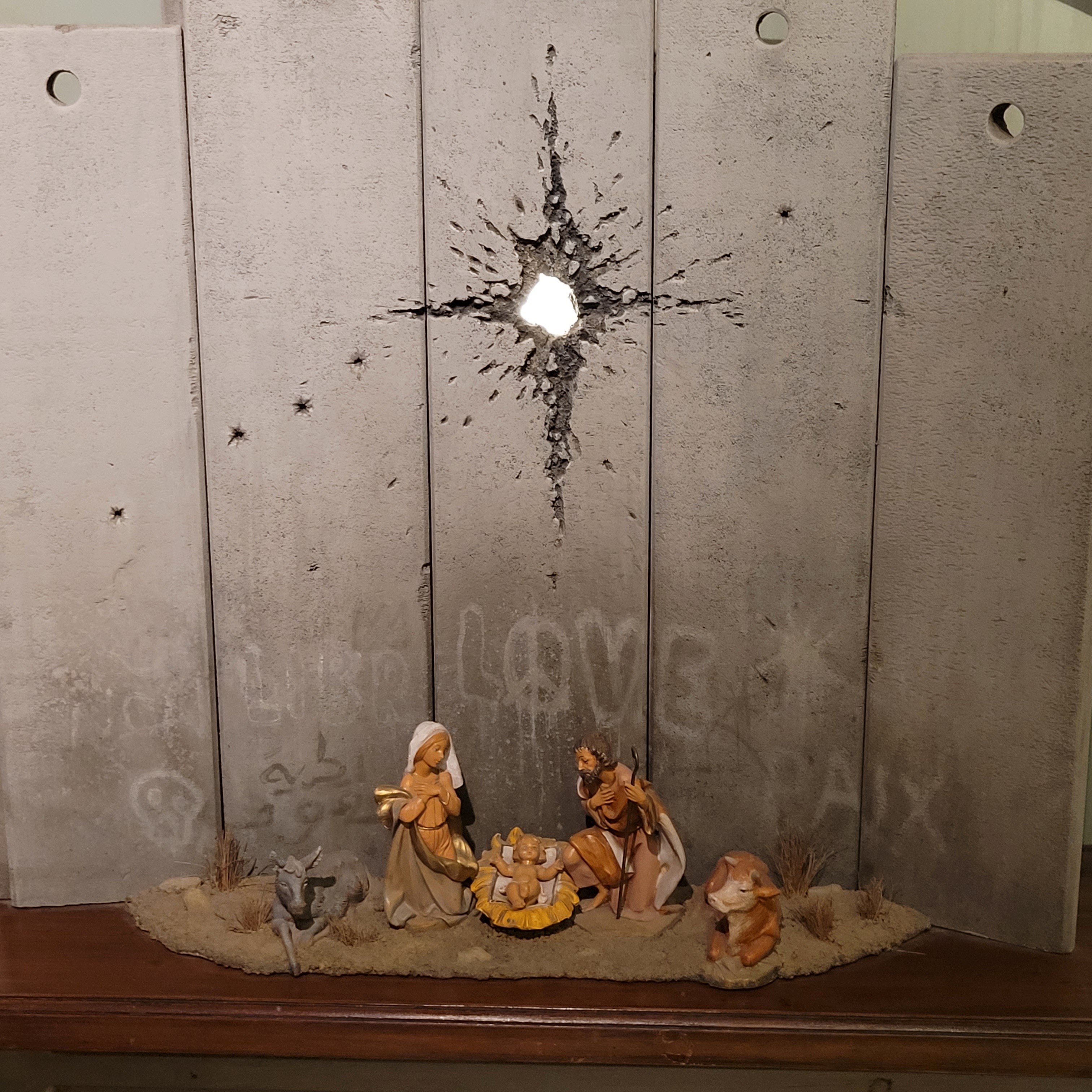 Nativity scene with a bullet hole star